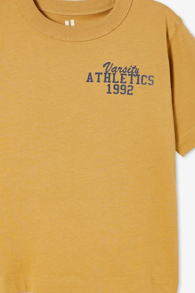 Boys Tops and TShirts Cotton On Jonny Short Sleeve Print Tee Mustard Seedvarsity Athletics 1992
